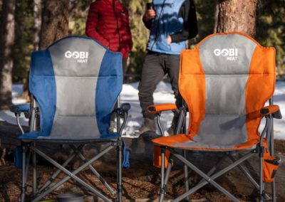 Two camping chairs with couple in the background